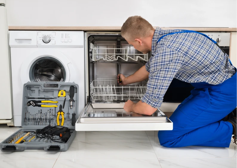 Man fixing dishwasher with tool kit